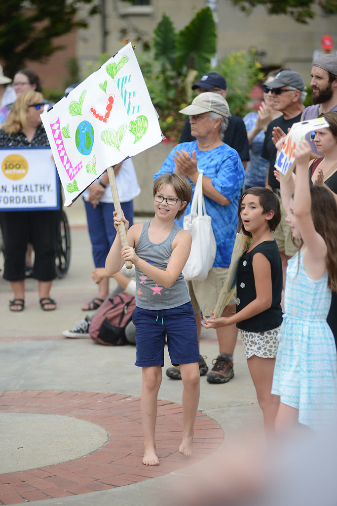 Sophie Stephens, 9, Chloe Wilkin, 10, and Esme Blauvelt, 9, cheer Friday at the Climate March